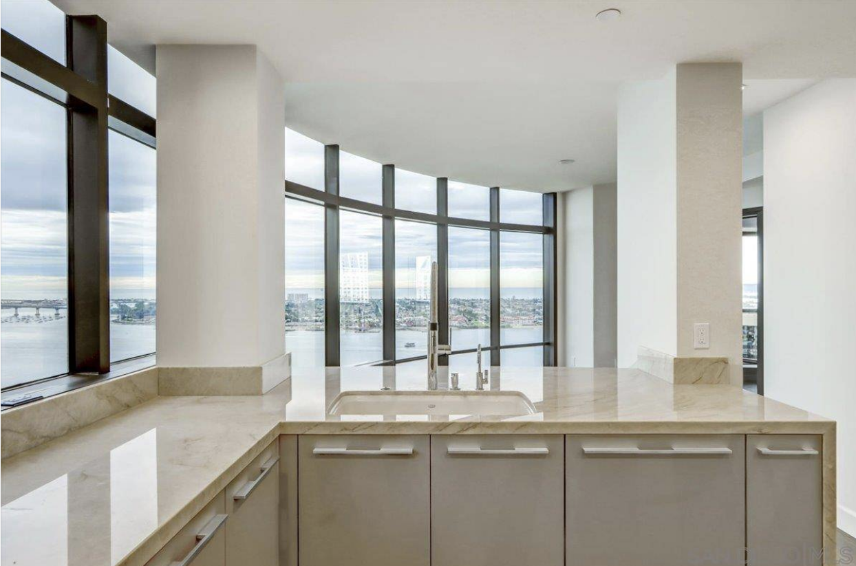 Kitchen with quartz countertops, floor-to-ceiling windows, high celings, view of the ocean